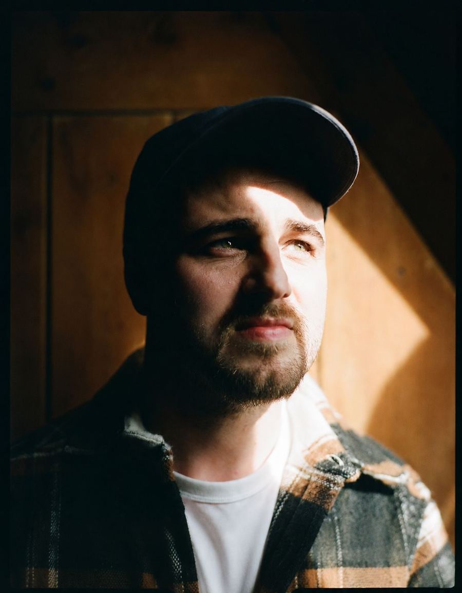 Elliott in a cap, a bar of sunlight across his face
