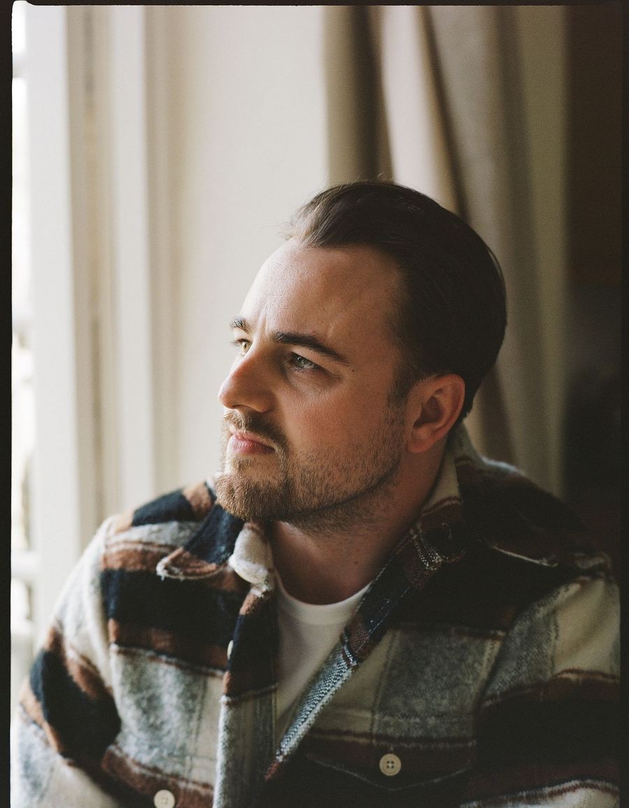 Elliott in profile by a bright window